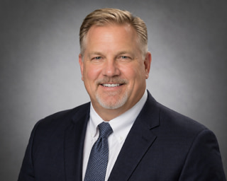 Dr. Bishopric T. Carroll, Chief Executive Director — Educational Auditors Team Corp